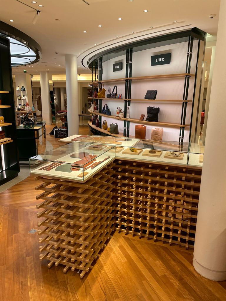 Wooden lattice display fixture in retail environment.